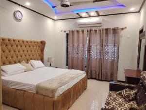 a bedroom with a large bed in a room at Britannia House near Islamabad International Airport and Motorway in Islamabad