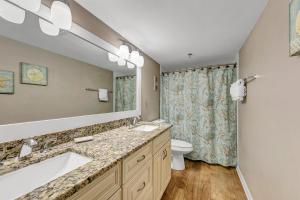 a bathroom with two sinks and a toilet at Destin on the Gulf 702 - Directly on the beach seventh floor with the best views in Destin +18 photos