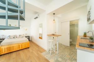 a bedroom with a bed and a sink in a room at Casa La Fontana 1 in Vejer de la Frontera