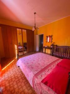 1 dormitorio con 1 cama grande con colcha rosa en Casa Franceschini en Poggio Mirteto