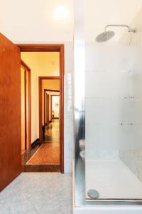 a hallway with a glass door leading to a room at Decana Flexyrent Apartment in Genoa