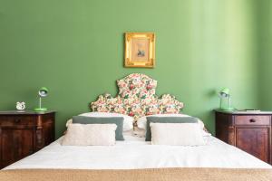 a bedroom with a large bed with a floral headboard at Decana Flexyrent Apartment in Genova