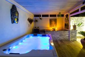 a large bath tub in a room with at Luxury Duplex - Private Jacuzzi - Center Hivernage in Marrakech
