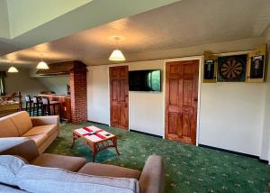 a living room with a couch and a table at Entire Spacious Bungalow Retreat in Bromsgrove