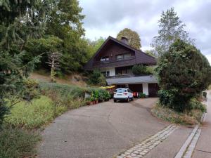 a house with a car parked in the driveway at Feldbergsicht in Lenzkirch