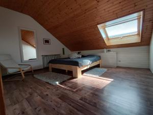 a bedroom with a bed and a window in a attic at Feldbergsicht in Lenzkirch