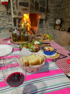 a table with a sandwich and a bowl of food and a fireplace at Guest House BOZVILL in Bozovec