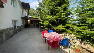 a table and chairs on the patio of a house at Guest House BOZVILL in Bozovec