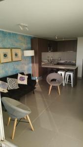 a living room with a couch and a table at Central de Arriendos Nueva Serena in La Serena