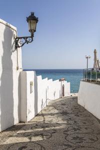a large stone wall with a light post on the side of the wall at Marissal by Dorobe Hotels in Nerja