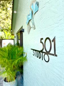 a house with a sign on the side of it at Zen.Modern.Hip “Studio 501” Beach,Scuba,Downtown in West Palm Beach