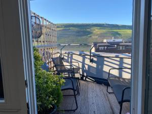 a balcony with chairs and a view of the countryside at HomeSweetHome#Bingen in Bingen am Rhein