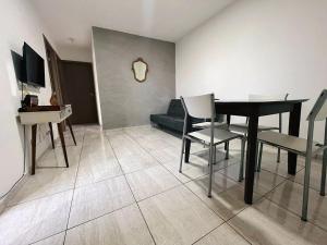 a living room with a table and chairs and a couch at Repouso São Miguel in Brasilia
