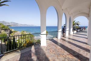 a walkway leading to a balcony overlooking the ocean at Marissal by Dorobe Hotels in Nerja