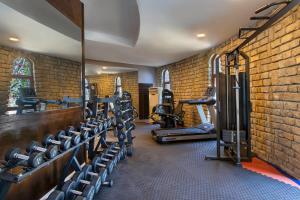 a gym with rows of tread machines in a brick wall at Başka Resort Bodrum in Bodrum City