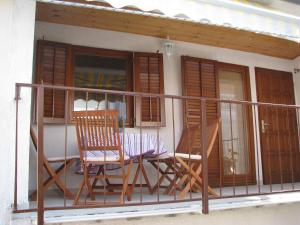a balcony with two chairs and a window at Holiday Home Mara in Tisno