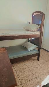 a couple of bunk beds with pillows on them at Pousada Litoral Norte Caragua in Caraguatatuba