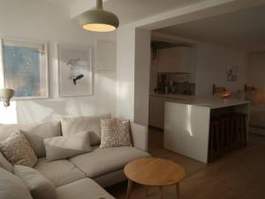 a living room with a white couch and a table at Moderne Studio Ferienwohnung in Bad Doberan in Bad Doberan