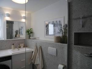a bathroom with a sink and a mirror at Moderne Studio Ferienwohnung in Bad Doberan in Bad Doberan