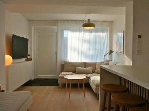 a living room with a couch and a table at Moderne Studio Ferienwohnung in Bad Doberan in Bad Doberan