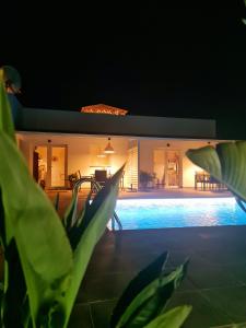 a house with a swimming pool at night at Villa Tino- Casa D in Los Llanos de Aridane