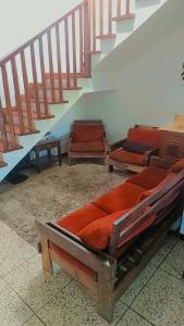 a room with two beds and a staircase at Pousada Litoral Norte Caragua in Caraguatatuba