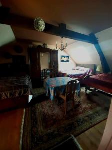 a living room with a table and a bed at Ferme Arboucau in Peyrouse