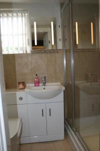 a bathroom with a sink and a shower at The Manor Guest House in Linton on Ouse