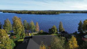 an aerial view of a lake with trees and houses at Nord Riverside in Rovaniemi