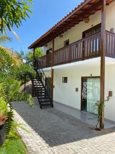 an exterior view of a house with a staircase at Pousada Casa Dunas in Barreirinhas