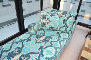 a blue chair with a pillow in front of a window at Villa Tusculum in Binz in Binz