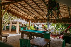 a pool table in a pavilion with a hammock at Barraca do Kite in Itarema