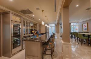 a kitchen with a bar and a dining room at voco St James Hotel by IHG in New Orleans