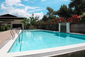 a swimming pool with blue water in a yard at homeist south almond drive in Talisay