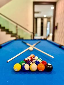 a clock on top of a pool table at Luxurious Home Villa , Ipoh with Karaoke, Snooker for 15-20 pax in Ipoh