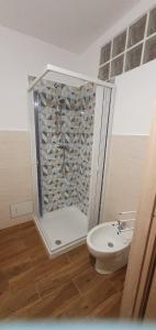 a bathroom with a shower with a toilet and a sink at Casa Torri in Tarquinia