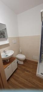 a bathroom with a white toilet and a sink at Casa Torri in Tarquinia