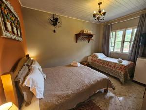 Cama ou camas em um quarto em Nina-Flor Pousada Lumiar