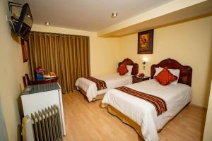 Voodi või voodid majutusasutuse Hotel Agustos Cusco toas