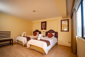 Voodi või voodid majutusasutuse Hotel Agustos Cusco toas