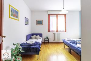 a bedroom with two beds and a window at FamilyBO Apartments Sant'Orsola in Bologna