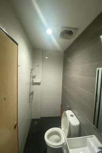 a bathroom with a toilet and a sink at OYO 92988 City Room in Nagoya