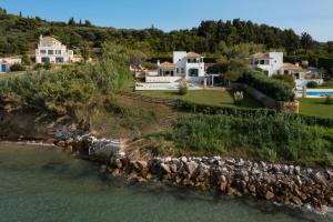 an aerial view of a house on an island in the water at Beachfront Villa Dionysos - With private beach in Sidari