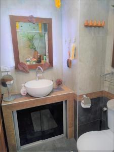 a bathroom with a sink and a mirror and a shower at Studio Viewtalay 3 Anastasiya in Pattaya South