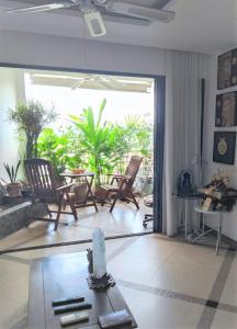 a living room with chairs and a table and a large window at Studio Viewtalay 3 Anastasiya in Pattaya South