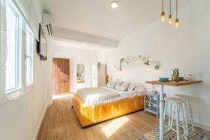 a bedroom with a bed and a table in it at Casa La Fontana 2 in Vejer de la Frontera