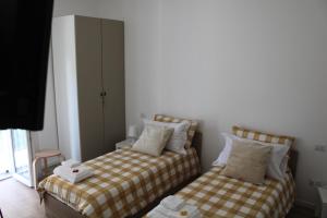 dwa łóżka ustawione obok siebie w pokoju w obiekcie B&B da Antonella w mieście San Donato Milanese