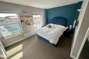 a bedroom with a bed with a dog laying on it at Charming 2BD Flat w Chic Terrace Kentish Town in London