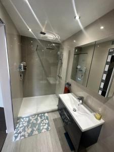 a bathroom with a shower and a sink and a mirror at Charming 2BD Flat w Chic Terrace Kentish Town in London