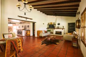 a living room with a couch and a fireplace at Posada La Celia in Eugenio Bustos